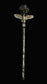 A decorative silver-toned staff or wand with a textured stem, a winged top detail, and a dark gemstone or crystal at the end, photographed against a black background.